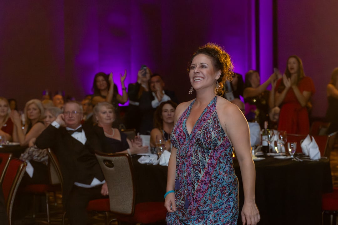 Woman walking up to the stage for her award