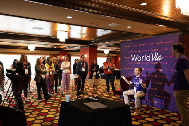 crowd of people watching a presentation at an event