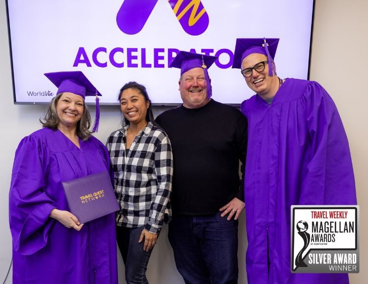 Image of travel advisor and WorldVia team wearing purple presenting an Accelerator diploma.