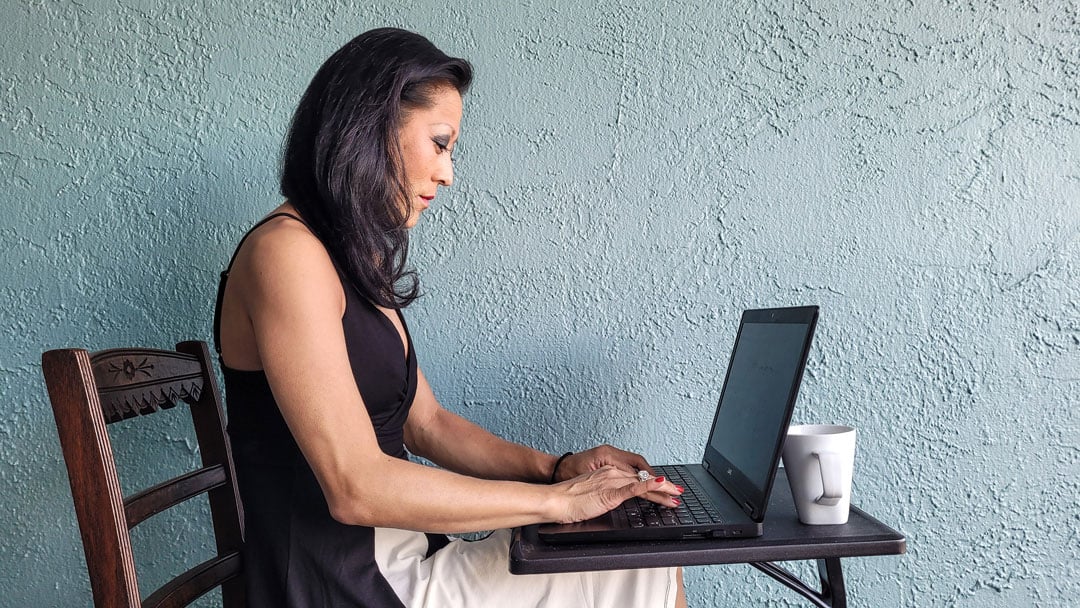 Business professional at desk working on laptop in startup office