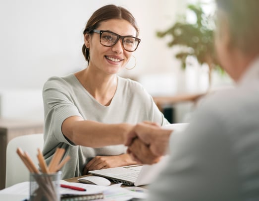 Woman shaking hands with a client