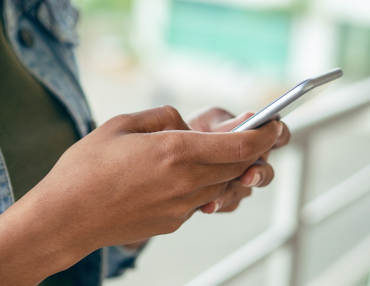 Woman sending text through a phone