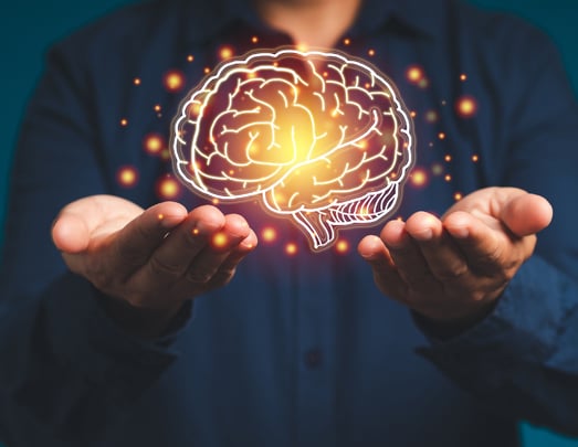 Image a hand holding a brain illuminated to showcase AI clarity