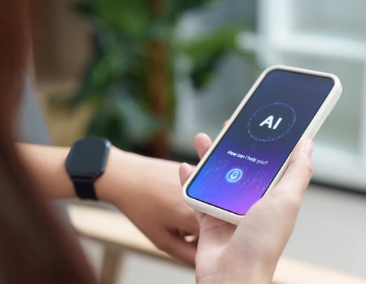 Image of a woman holding a phone showing ai and the text "how can i help you?"