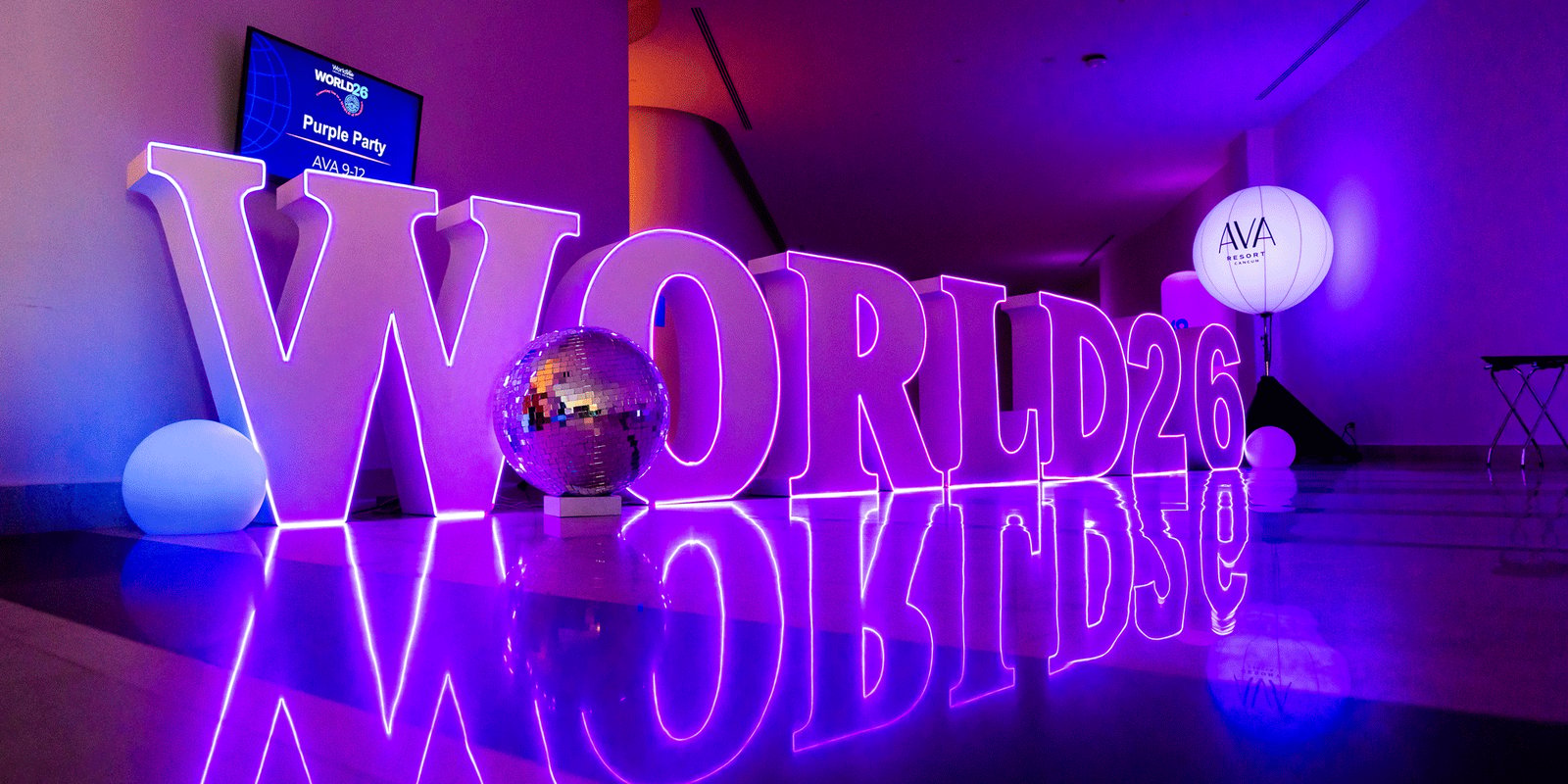 WORLD26 in lights with a disco ball