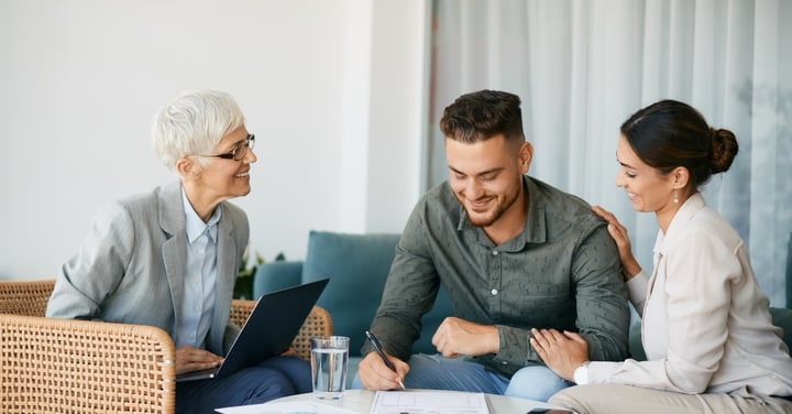 Smiling couple meeting with advisor in office