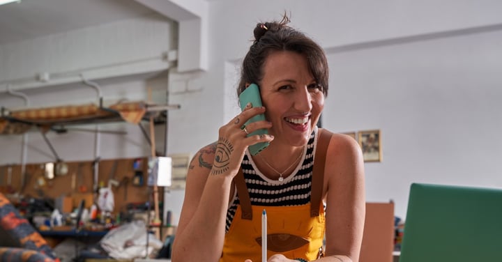 Smiling woman working from home on the phone