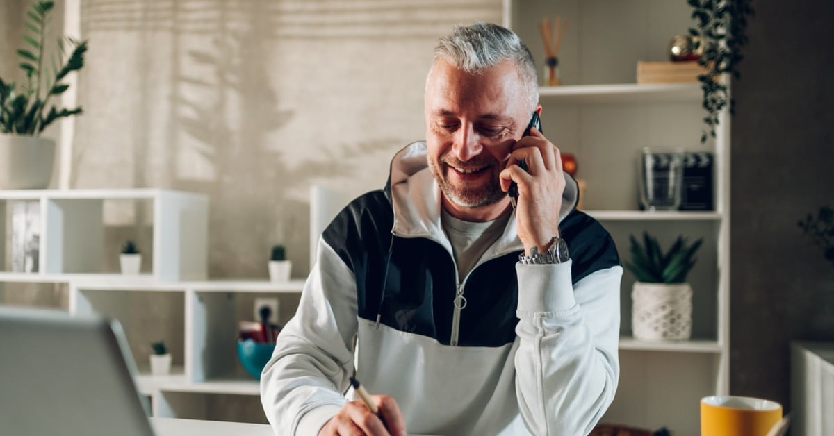 Experienced travel advisor on a client call in his home office