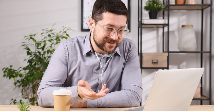 Professional man in a video conference at desk