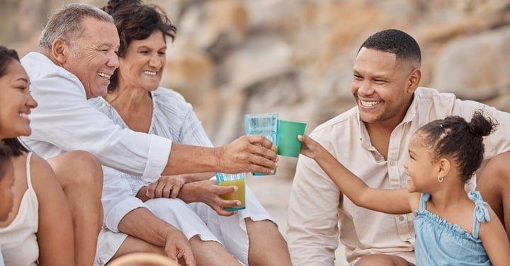 Generational family enjoying a picnic at the beach