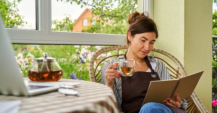 Woman relaxing with tea and book at home