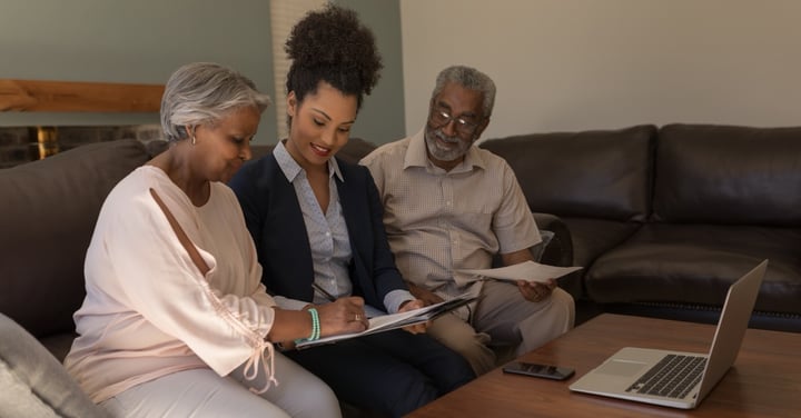Advisor meeting with mature couple in their home