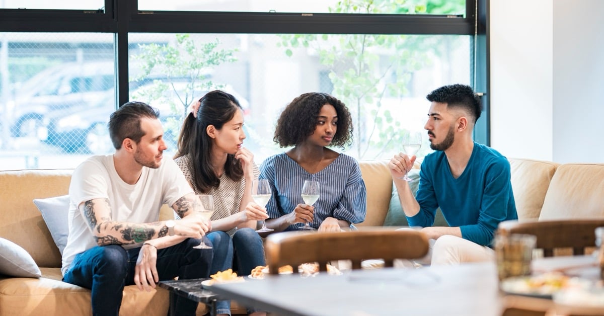Four travel advisors meeting around a coffee table