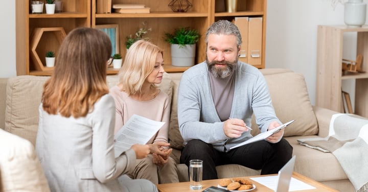 Couple meeting advisor at home office