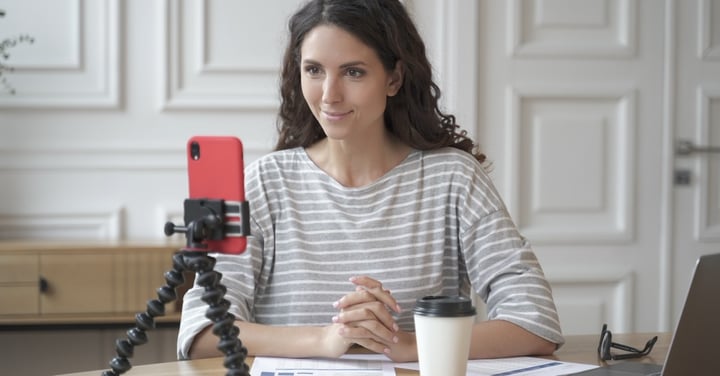 Woman broadcasting with a smartphone at home