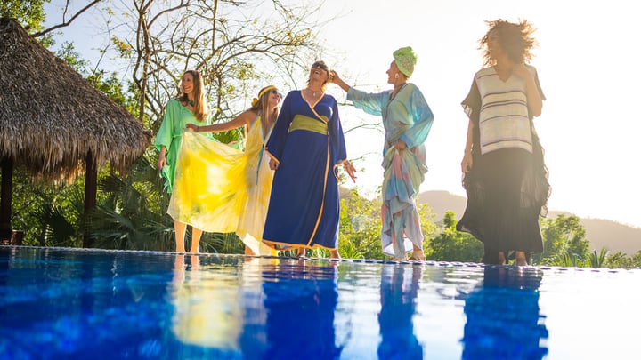 Models with long dresses on an outdoor pool