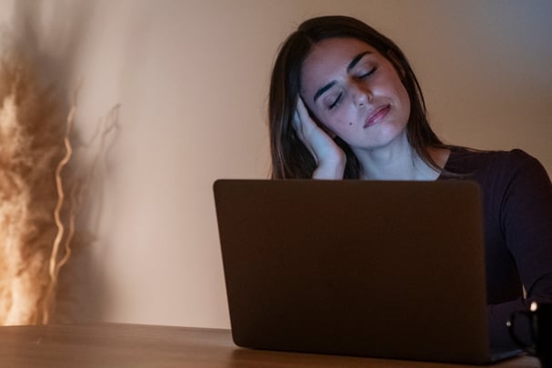 Tired businesswoman working on computer until night. Portrait of a stressed casual woman