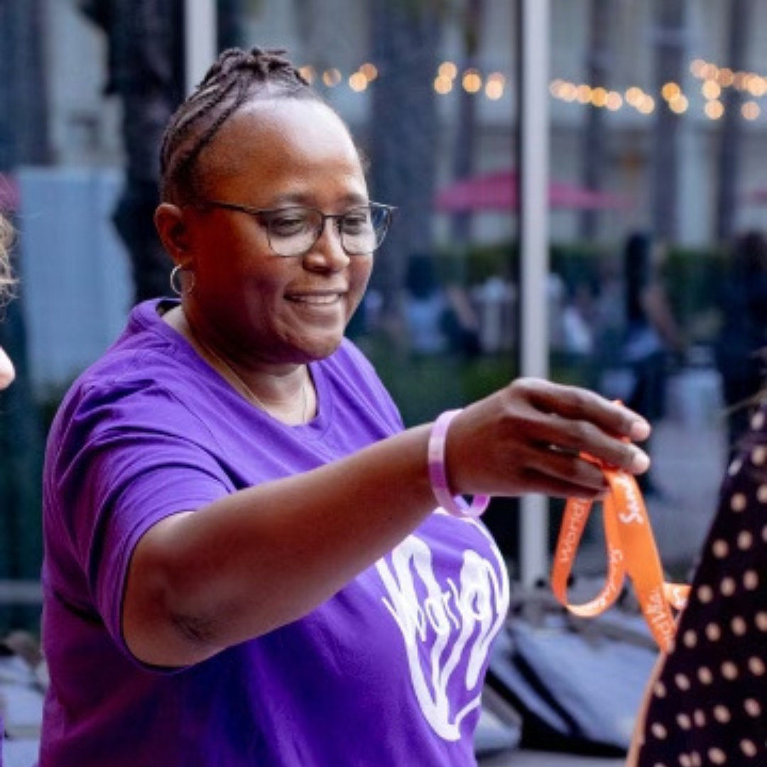 Relia Thomas handing out lanyards at WORLD24