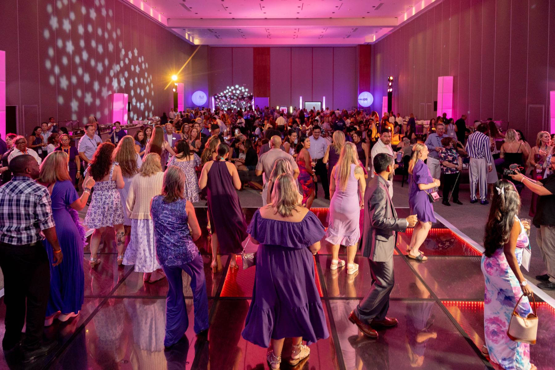 A crowded dance floor at the WORLD26 Purple Party