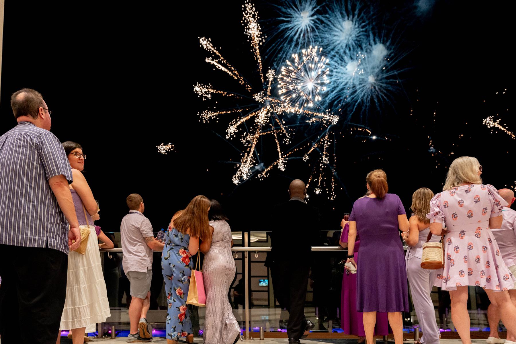 Members watching fireworks over the water at WORLD26