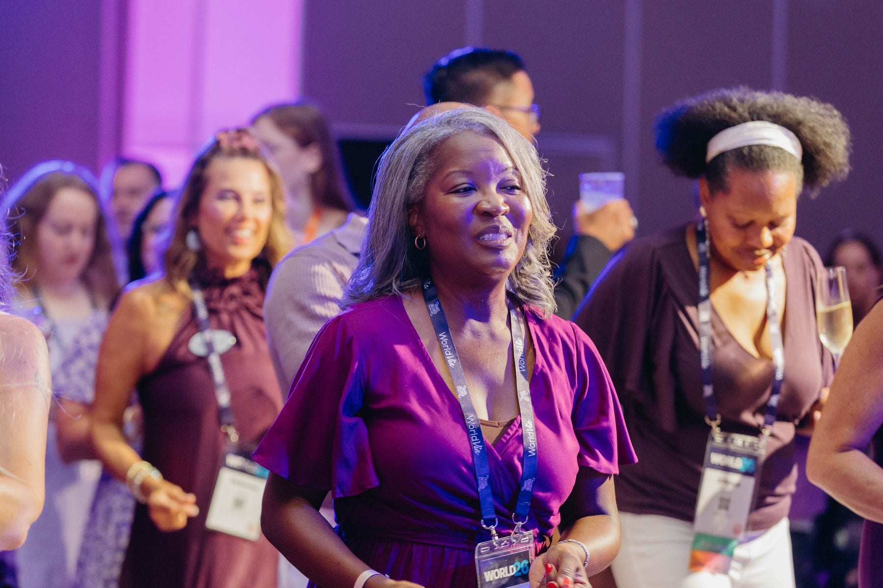 Members smiling together at the WORLD26 Purple Party